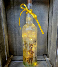 Load image into Gallery viewer, Decorative bottle with Alpaca design LED lights and a yellow ribbon on a wooden surface.