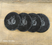 Load image into Gallery viewer, Set of four black slate coasters with Bee design on a wooden surface