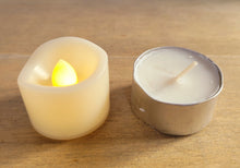 Load image into Gallery viewer, plastic votive candle, switched on, small white tealight candle next door to it
