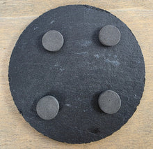 Load image into Gallery viewer, Round black slate coaster with four pads on the underside