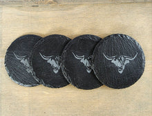 Load image into Gallery viewer, Four black round slate coasters with a cows head design on a wooden surface