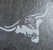 Load image into Gallery viewer, Engraved cows head design on a dark stone surface