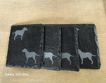 Load image into Gallery viewer, Four black slate coasters each with two labrador etched images on - dogs facing eachother
