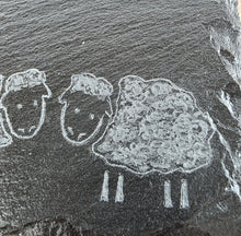 Load image into Gallery viewer, Rock engraving of three sheep on a dark stone slate tile
