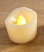Load image into Gallery viewer, cream coloured plastic votive flameless candle, lit up