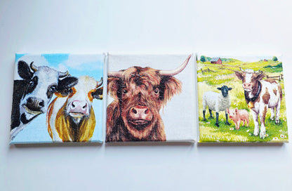 set of three cow pictures on square stretched canvas. Each has different design. Decoupage technique with sparkly finish.