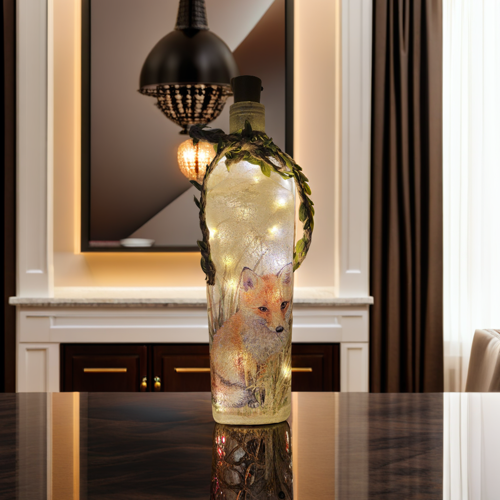 Decoupage Fox Bottle Lamp - Lit up square gin bottle with fox detail and jute twine with leaves wrapped around the neck of the bottle. Cork LED lights