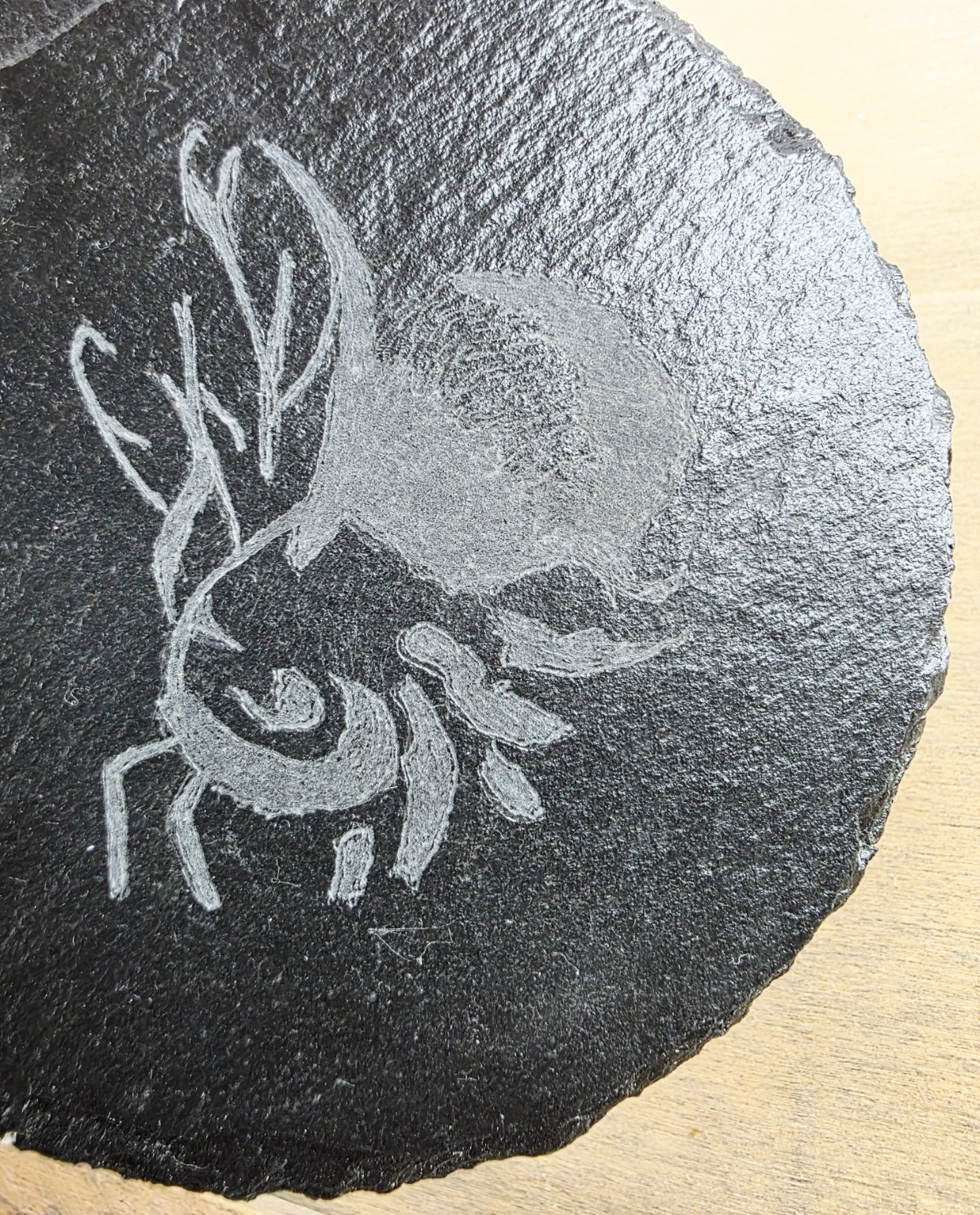 Sculpted bee design on a dark stone surface