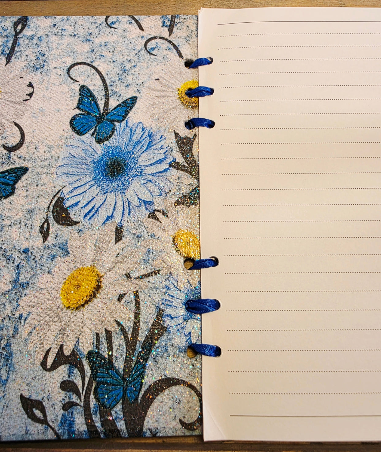 Notebook with blue floral and butterfly design on cover and lined pages