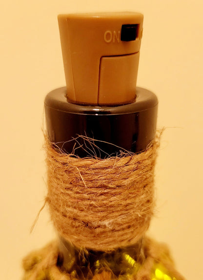 Braided Green Glass Bottle Lamp - plastic cork with black switch in the top of a bottle. Jute string wrapped around the neck