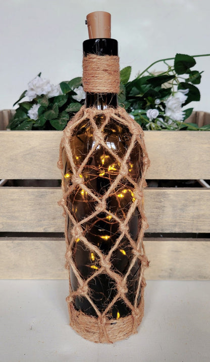 braided jute string bottle with green glass and LED lights. Brown plastic cork