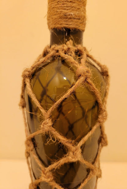 braided jute string bottle with green glass and LED lights. Brown plastic cork