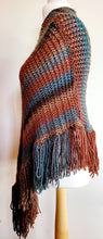 Load image into Gallery viewer, Brown and Blue Hand Knitted Striped Poncho - Knitted brown, blue poncho with round neck and long tassels, side view on a mannequin
