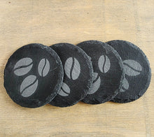 Load image into Gallery viewer, Four black slate coasters with coffee bean design on a wooden surface

