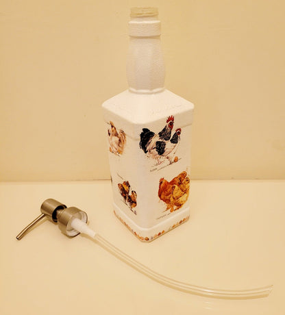 Country Inspired Soap Dispenser - white painted bottle with chickens detail around the sides. Silver pump head and tube lying next door to it