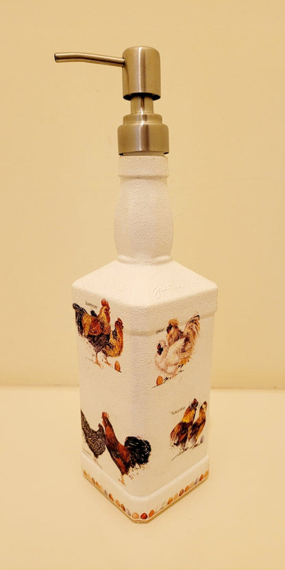 Jack daniels shaped bottle, painted white with chickens detailing around the sides, eggs around the edge at the bottom. Silver pump head