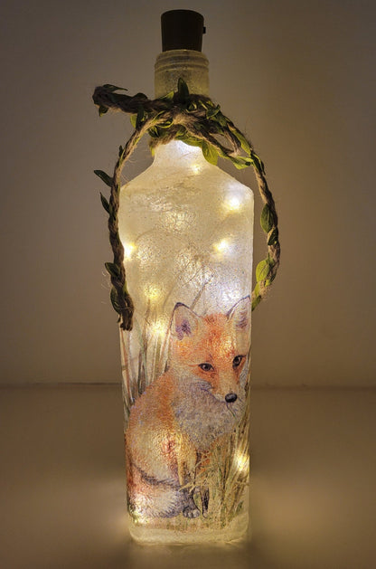 Decoupage Fox Bottle Lamp - Lit up square gin bottle with fox detail and jute twine with leaves wrapped around the neck of the bottle. Cork LED lights