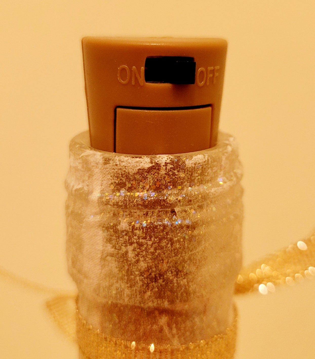 brown plastic cork with black switch in the top of a wine bottle