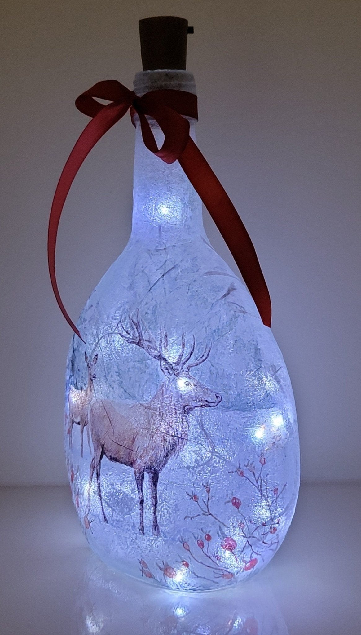 Decoupage Stag Light Up Bottle - Lit up Round glass bottle with Stag detailing. Red bow tied around the neck of the bottle, cork LED lights