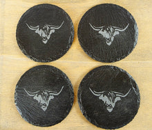 Load image into Gallery viewer, Four black slate coasters with cow's head design on a wooden surface
