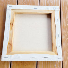 Load image into Gallery viewer, rear side of a canvas showing the wood and staples
