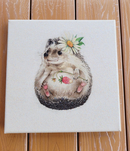 Canvas print of a hedgehog with a flower on a wooden surface