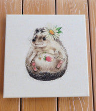 Load image into Gallery viewer, Canvas print of a hedgehog with a flower on a wooden surface
