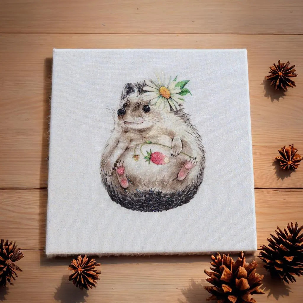 Canvas print of a hedgehog with flowers on a wooden surface with pine cones.