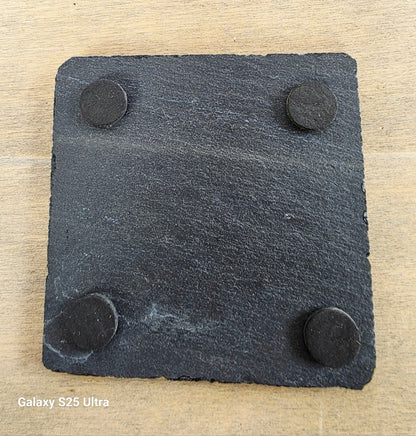 square slate coaster showing four protective pads on the underside