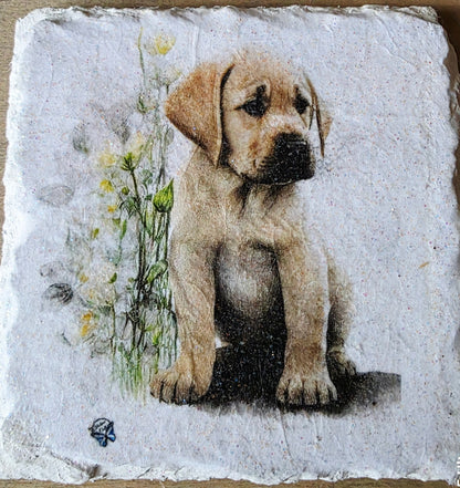 Artistic depiction of a golden labrador puppy surrounded by flowers on a white painted slate coaster