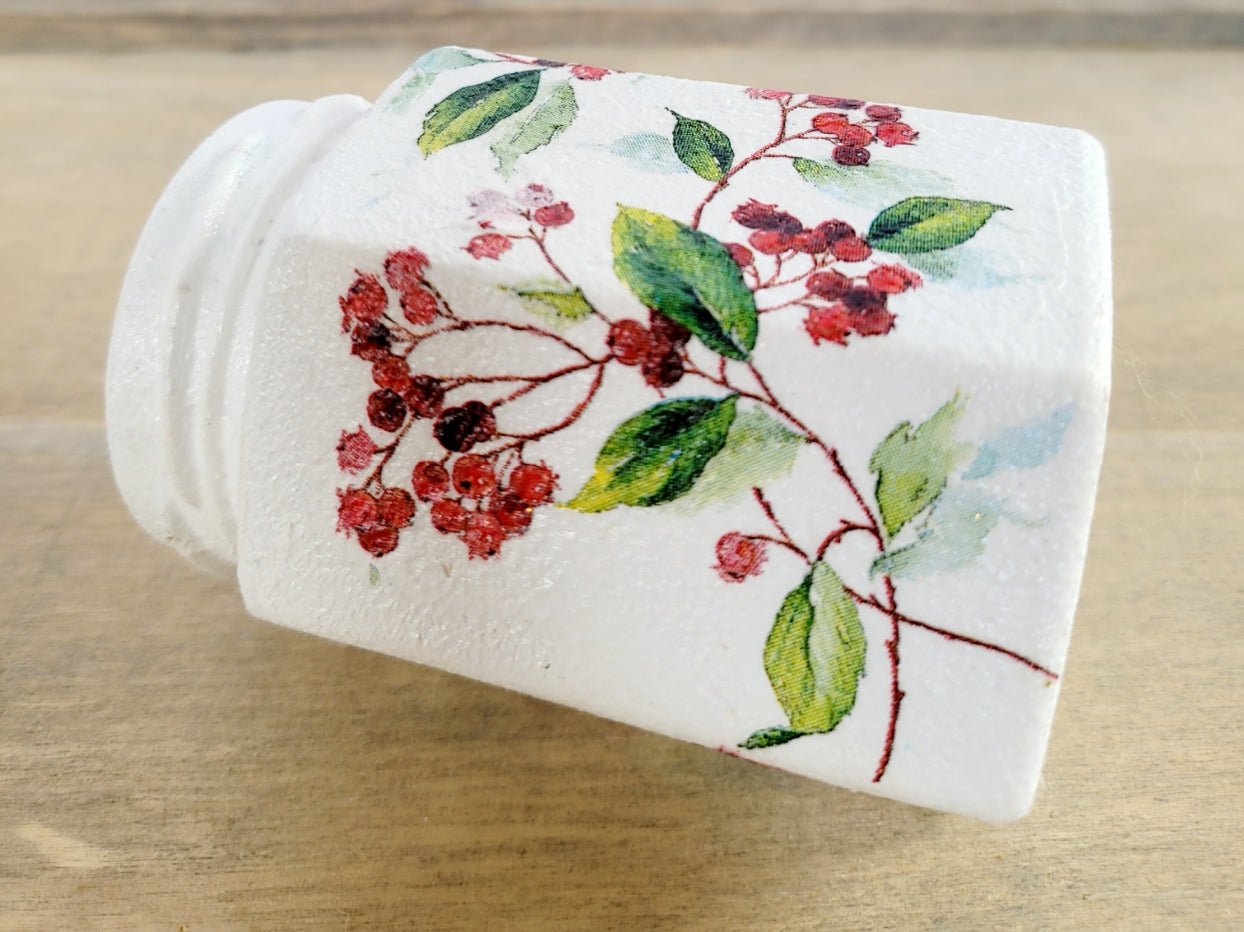 White painted hexagonal shaped jar with green and red berry leaf design