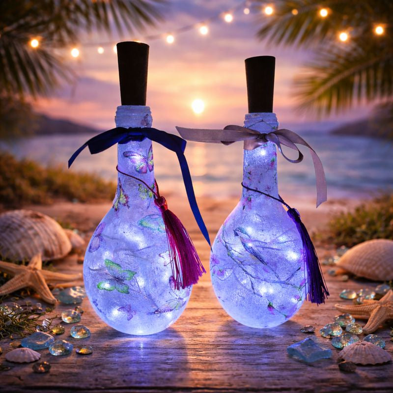Two decorative miniature bottles with LED lights and bird design on a sparkling background