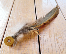 Load image into Gallery viewer, Pheasant feather hat pin, long pheasant tail feather with shorter feathers on the end of a brass gold coloured shotgun cartridge
