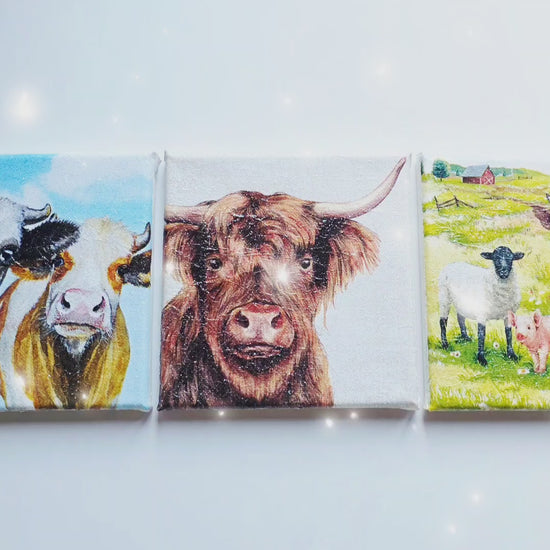 video of a set of three cow pictures on square stretched canvas. Each has different design. Decoupage technique with sparkly finish.