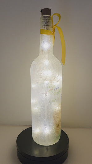 Lit up bottle with Alpacas on. Yellow ribbon embellishment