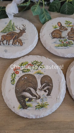 Video view of a Round white painted slate coasters, four, with Badger, Rabbit, Stag and Robin design. Snowy backgrounds