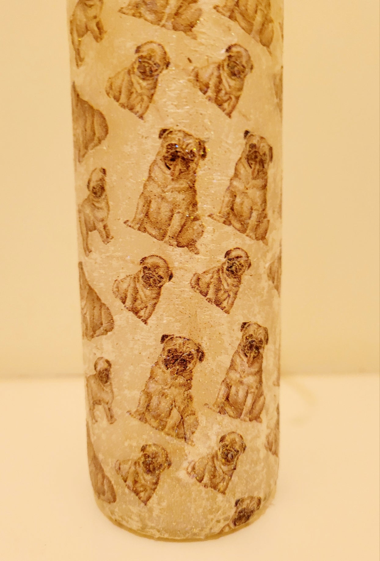 wine bottle decorated with tiny pug dog images. 