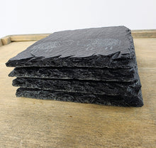 Load image into Gallery viewer, Stack of black slate tiles on a wooden surface
