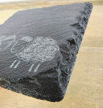 Load image into Gallery viewer, Slate coaster with engraved sheep design on a wooden surface
