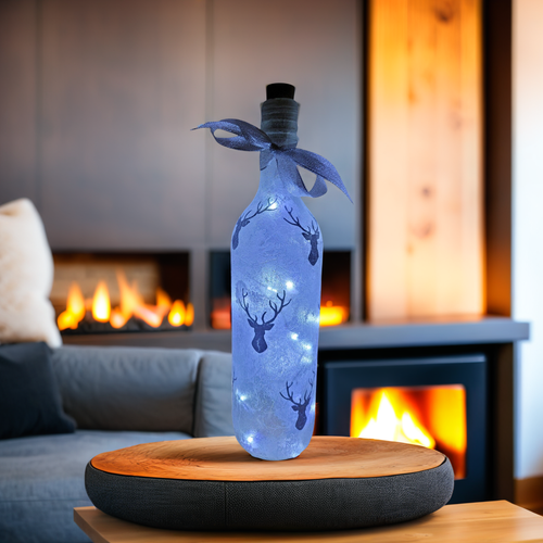 standard wine bottle with frosted stag's heads design. cork LED lights and silver ribbon around the neck of the bottle