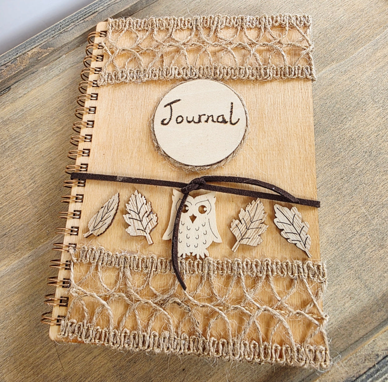 Wooden journal with decorative wooden leaves and owl elements. Burlap jute decoration top and bottom. Faux suede tie