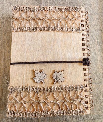 Wooden journal with decorative wooden leaf elements. Burlap jute decoration top and bottom. Faux suede tie