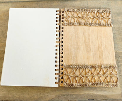 Wooden notebook with burlap decoration on the back inside cover. Plain pages. Metal spiral bound edge