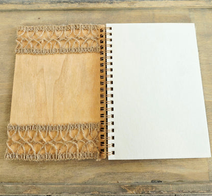 Open wooden notebook with a decorative inside cover of burlap decoration top and bottom. Plain pages 