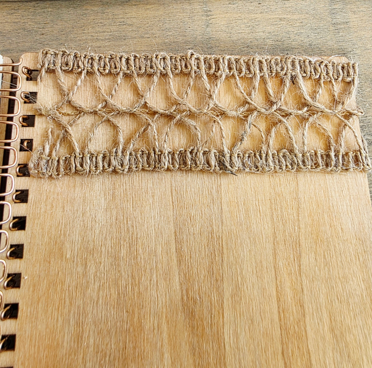 Close-up of burlap jute  texture on a wooden spiral bound notebook
