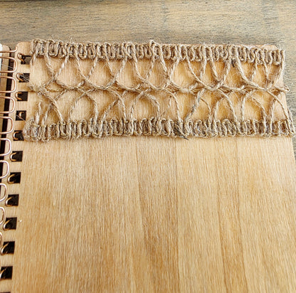 Close-up of burlap jute  texture on a wooden spiral bound notebook