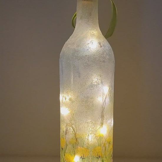 Rotating example of a Lit up wine bottle with Hare detail, cork LED lights and green bow