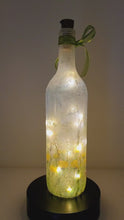 Load and play video in Gallery viewer, Rotating example of a Lit up wine bottle with Hare detail, cork LED lights and green bow
