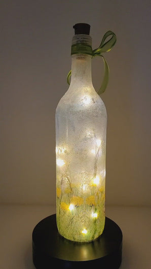 Rotating example of a Lit up wine bottle with Hare detail, cork LED lights and green bow