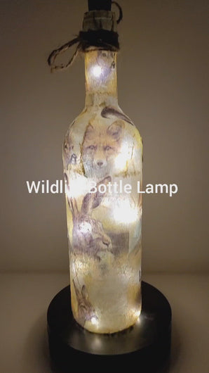 Rotating Lit up wine bottle with wildlife detail. Jute string bow